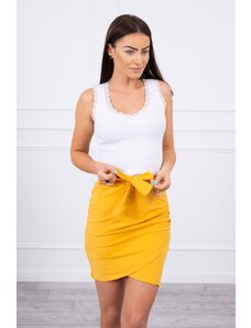 Kesi Wrap skirt tied at the waist with mustard