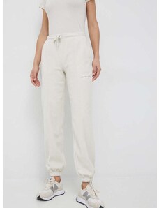 Tepláky Calvin Klein Jeans dámske, béžová farba, s nášivkou