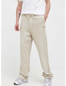 Bavlnené tepláky Tommy Jeans béžová farba, jednofarebné
