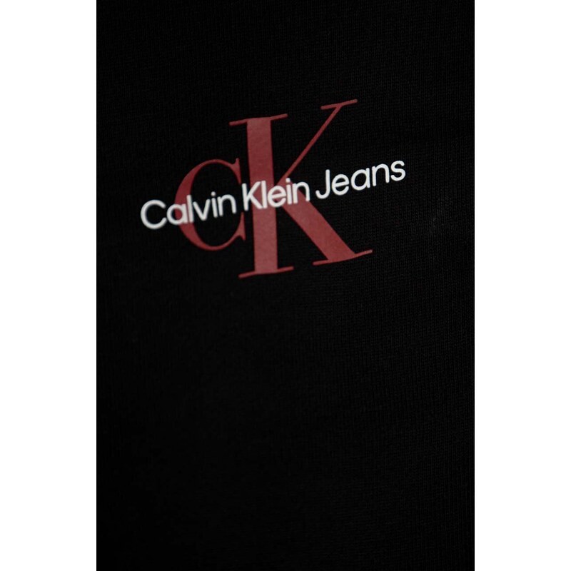 Detské bavlnené tepláky Calvin Klein Jeans čierna farba, s potlačou