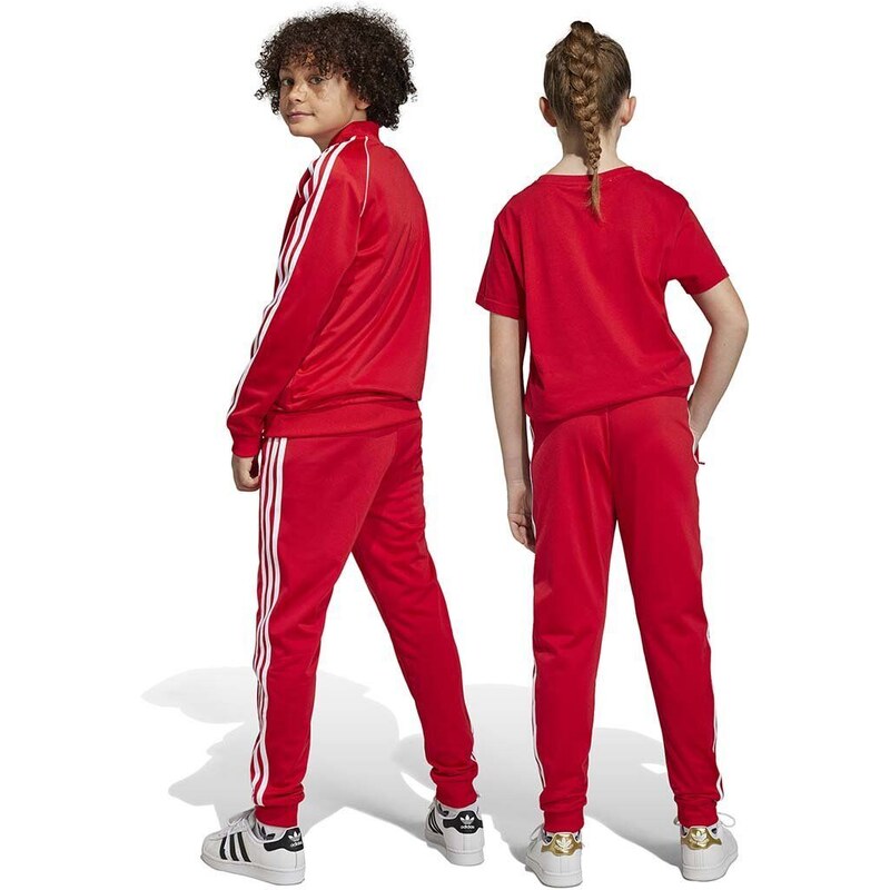 Detské tepláky adidas Originals červená farba, vzorované