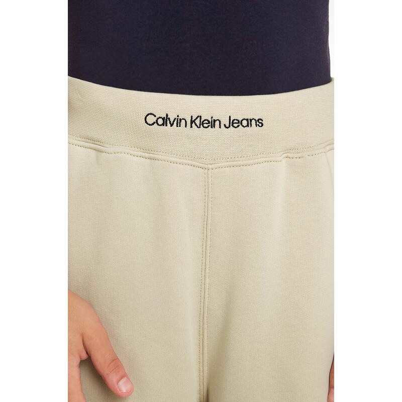Detské tepláky Calvin Klein Jeans béžová farba, jednofarebné