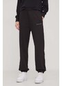 Bavlnené tepláky Tommy Jeans čierna farba, s nášivkou, DW0DW17309